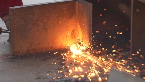 Welding work. A worker welds chains at a factory Stock Footage 285962624