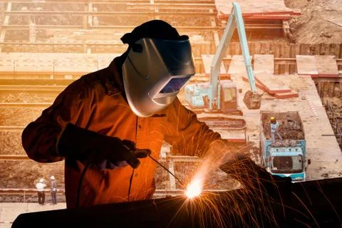 Welding worker welding steel structure with construction crane and building Stock Photos