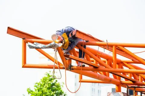 The welding workers at structures site. Worker is welding steel structures. Stockfoto's