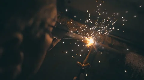Welding works on a black background and a lot of sparks flying around Stock Footage 64878364