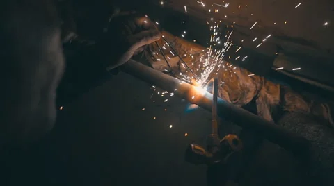 Welding works on a black background and a lot of sparks flying around Stock Footage 64878487