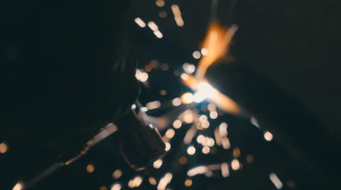 Welding works on a black background and a lot of sparks flying around Stock Footage 64878556