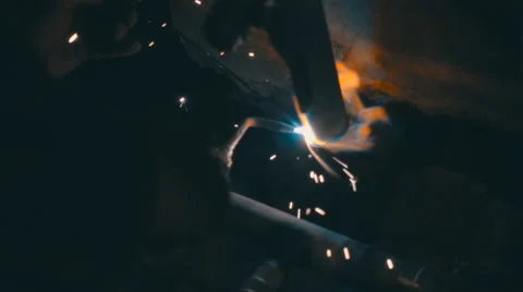 Welding works on a black background and a lot of sparks flying around Stock Footage 64878574