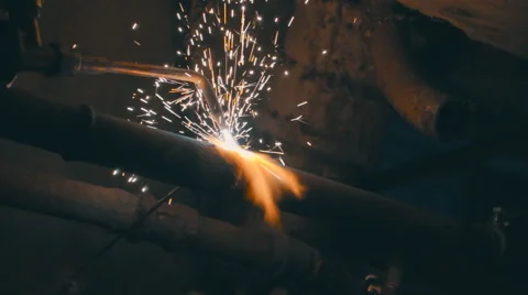 Welding works on a black background and a lot of sparks flying around Stock Footage 64878598