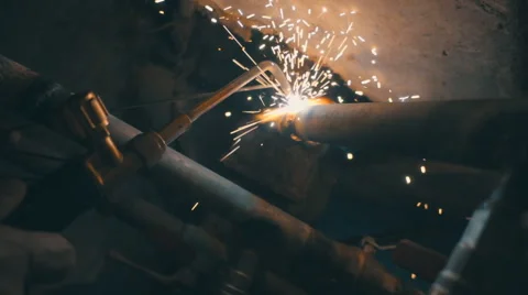 Welding works on a black background and a lot of sparks flying around Stock Footage 64878616