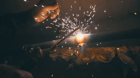 Welding works on a black background and a lot of sparks flying around Stock Footage 64878707