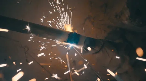 Welding works on a black background and a lot of sparks flying around Stock Footage 64878745