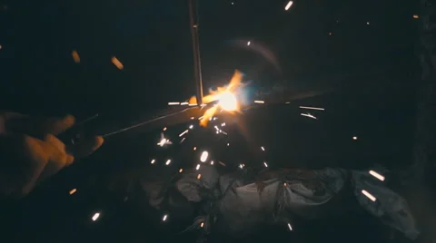 Welding works on a black background and a lot of sparks flying around Stock Footage 64878811