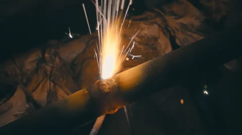 Welding works on a black background and a lot of sparks flying around Stock Footage 64878846