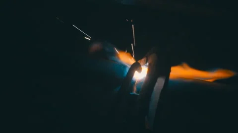Welding works on a black background and a lot of sparks flying around Stock Footage 64878853