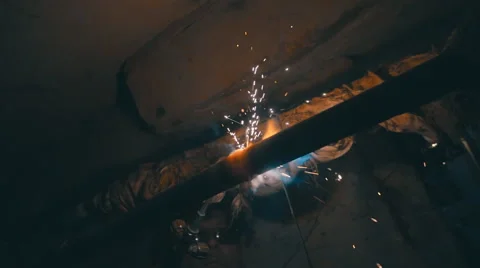 Welding works on a black background and a lot of sparks flying around Stock Footage 64878918
