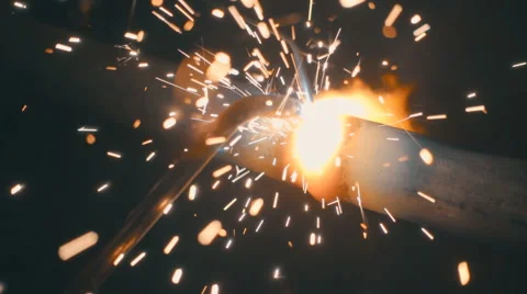 Welding works on a black background and a lot of sparks flying around Stock Footage 64878965