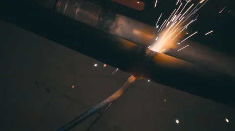 Welding works on a black background and a lot of sparks flying around Stock Footage 64878966