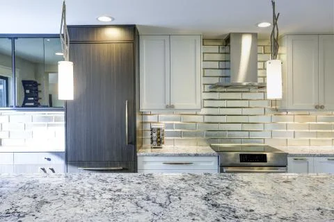 Well appointed kitchen features a large kitchen island, gray quartzite counte Stock Photos