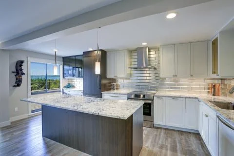 Well appointed kitchen features a large kitchen island, gray quartzite counte Stock Photos