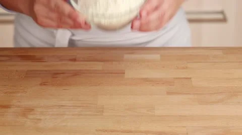 A well being made in a pile of flour on a work surface Stock Footage 24669606