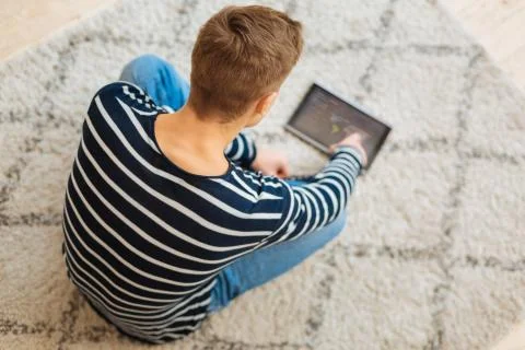 Well-built boy using his tablet Stock Photos