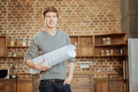 Well-built engineer posing with a blueprint Stock Photos