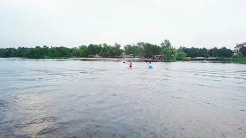 Well-coordinated team kayaking on lake Stock Footage 137292631