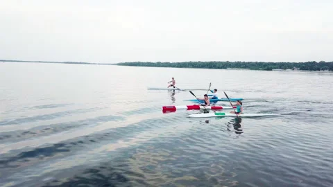 Well-coordinated team kayaking on lake Stock-Footage 137292856