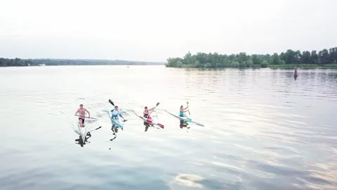 Well-coordinated team kayaking on lake Stock Footage 137293148