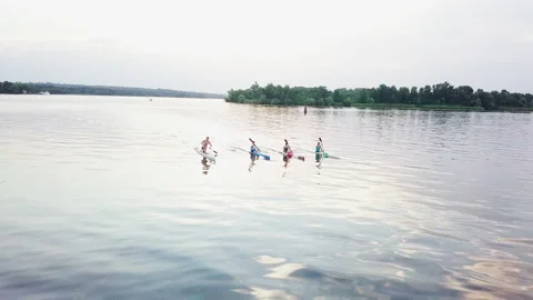 Well-coordinated team kayaking on lake Stock Footage 137293227
