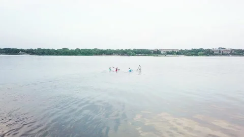 Well-coordinated team kayaking on lake Stock Footage 137293406