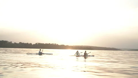 Well-coordinated team kayaking on river Stock Footage 135864418