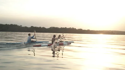 Well-coordinated team kayaking on river Stock Footage 135865602