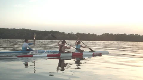 Well-coordinated team kayaking on river Stock Footage 135865712