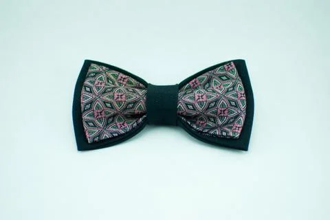 Well-designed stylish dark-colored bow tie made of soft cloth Stock Photos