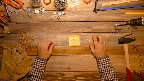 Well done. Craftsman holding note stick with world done on it. Stock Footage 70686470