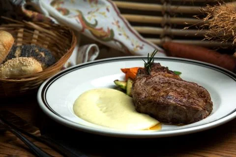 Well-done steak with mashed potatoes and fried vegetables Stock Photos