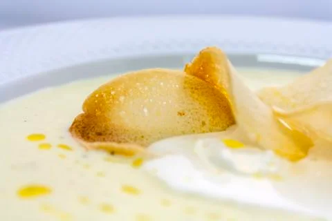 Well-done thin slices croutons in a creamy soup mashed butter Stock Photos