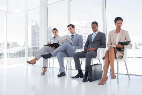 Well dressed business people sat together Stock Photos