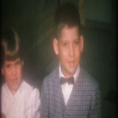 Well dressed children kiss each other for camera 1950s vintage home movie 3773 Stock Footage 69405671