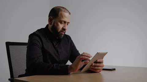 Well Dressed Hispanic Man Working on an IPad Stock Footage 124699556