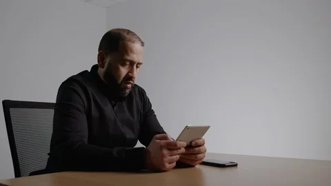 Well Dressed Hispanic Man Working on an IPad Stock Footage 124699566