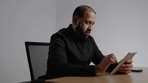 Well Dressed Hispanic Man Working on an IPad Stock Footage 124699601