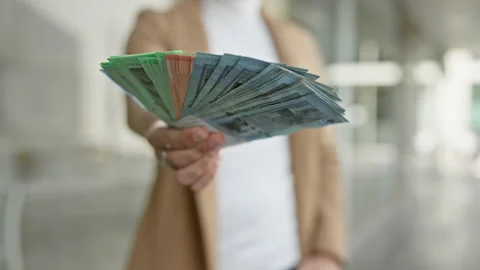 A well-dressed man displays a spread of malaysian ringgit banknotes on an u.. Stock Footage 268581325