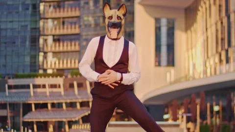 Well dressed masked man dancing in the city corporate district Stock Footage 116271159