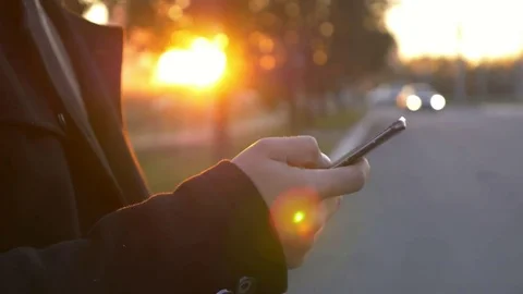Well-dressed trendy man talking with mobile phone in a city on sunset time Stock Footage 80940512