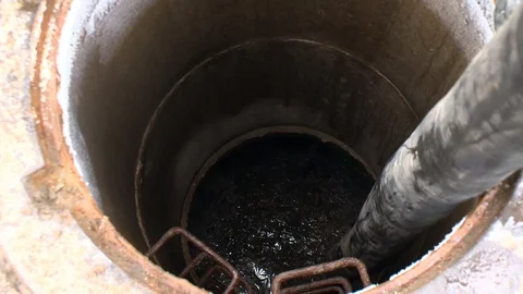 Well full of sewerage faeces and hose pumping off shit Stock Footage 109401060