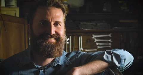 Well-groomed handsome bearded master hipster, specialist in bicycles Stock Footage