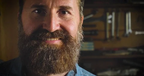 Well-groomed handsome bearded master hipster, specialist in bicycles Stock Footage