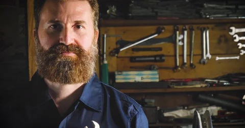 Well-groomed handsome bearded master hipster, specialist in bicycles Stock Footage