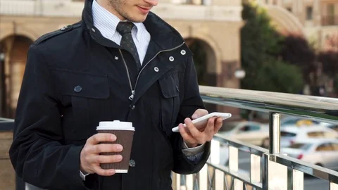 A well-groomed man is typing something in his mobile phone Stock Footage 83176723