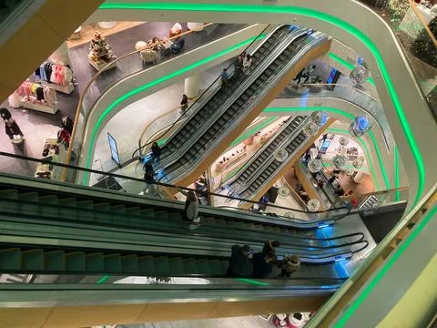 A well-lit, multi-level mall with operational escalators and elevators Shop.. Foto stock