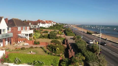 Well maintained gardens in front of luxurious properties along sea coast Video stock 161057269
