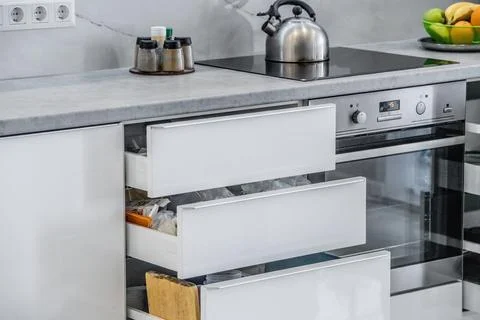 Well organized modern kitchen, three drawers are open Stock Photos